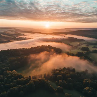 Aerial view of a misty valley during sunrise - Image 1