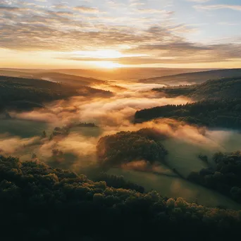 Aerial view of a misty valley during sunrise - Image 3