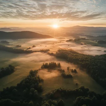 Aerial view of a misty valley during sunrise - Image 4