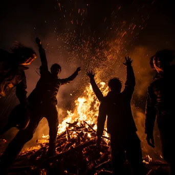 Close-up of bonfire embers with friends in the background - Image 1