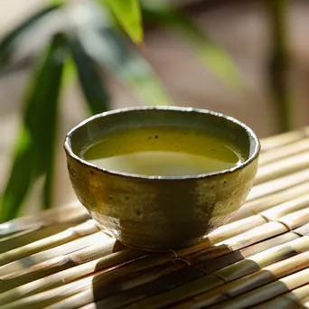 Close-up of brewed green tea with bamboo in the background. - Image 4