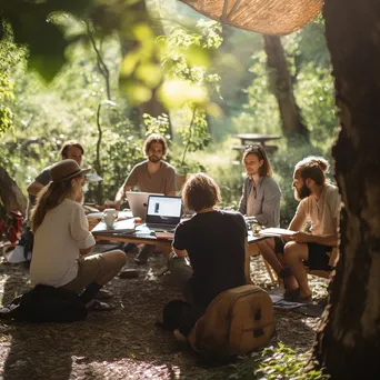 Individuals brainstorming in nature with laptops - Image 2