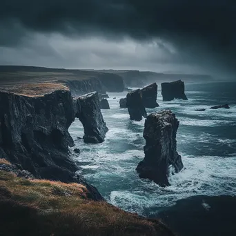 Coastal sea stacks under dark, rainy skies - Image 2