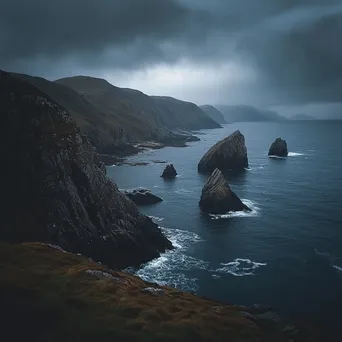 Coastal sea stacks under dark, rainy skies - Image 4