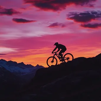 Silhouette of a mountain biker against a colorful sunset backdrop. - Image 3