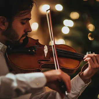 Violinist playing softly under ambient lighting during a performance. - Image 3