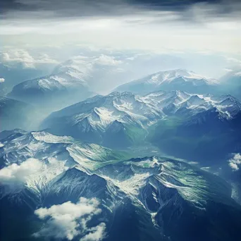 Majestic snow-capped mountains and green valleys seen from airplane window in aerial shot - Image 4