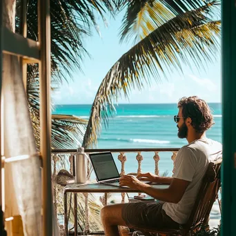 Digital nomad presenting workshop on balcony with ocean view - Image 1