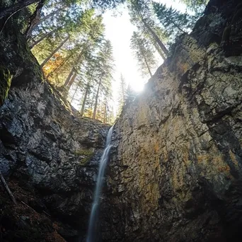 Cascading Waterfall by Mountain Rock Wall