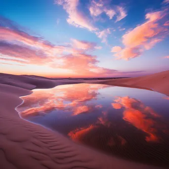 Sunrise over rolling sand dunes with vibrant colors - Image 2