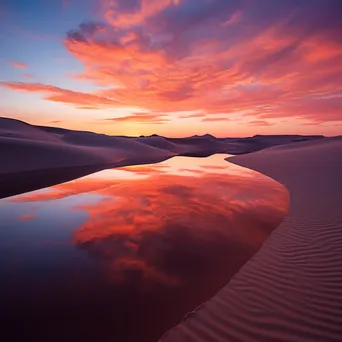 Sunrise over rolling sand dunes with vibrant colors - Image 4