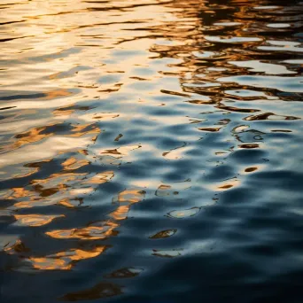 Reflective light patterns on calm lake with glowing reflections - Image 2