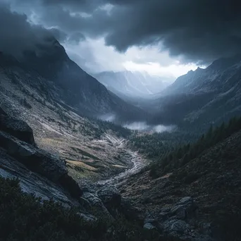 Mountain valley under stormy skies with rain and rugged terrain - Image 1