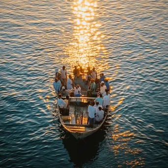 Pearl diving community gathering near boat at sunset - Image 3