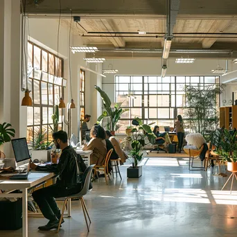 Modern shared office with desks in natural light - Image 1