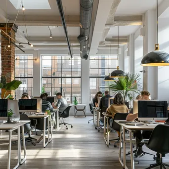 Modern shared office with desks in natural light - Image 3