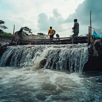 Fishermen using a traditional weir in a river - Image 1