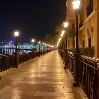 Calm riverside promenade with gentle streetlights overlooking city views at night - Image 2