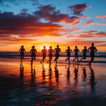 Silhouette of friends running along the beach during sunset - Image 4