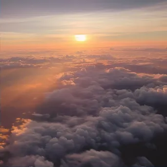 Sunset above clouds creating colorful sky seen from airplane window - Image 2