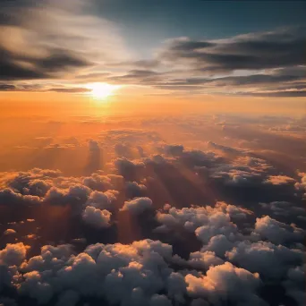 Sunset above clouds creating colorful sky seen from airplane window - Image 3