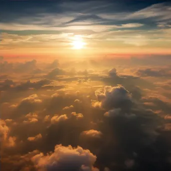 Sunset above clouds creating colorful sky seen from airplane window - Image 4