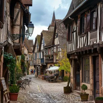 Quaint medieval village with cobblestone streets and timber-framed houses, lively marketplace in the square - Image 4