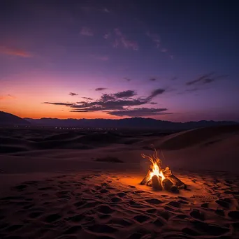 Campfire glowing against sand dunes at twilight - Image 4