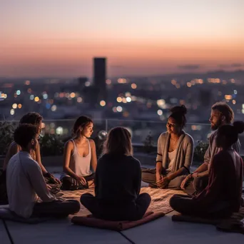 Group meditating on a rooftop terrace - Image 1